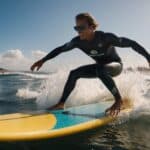 Surfing competition formats: riders navigating waves, judges scoring, spectators cheering on the beach